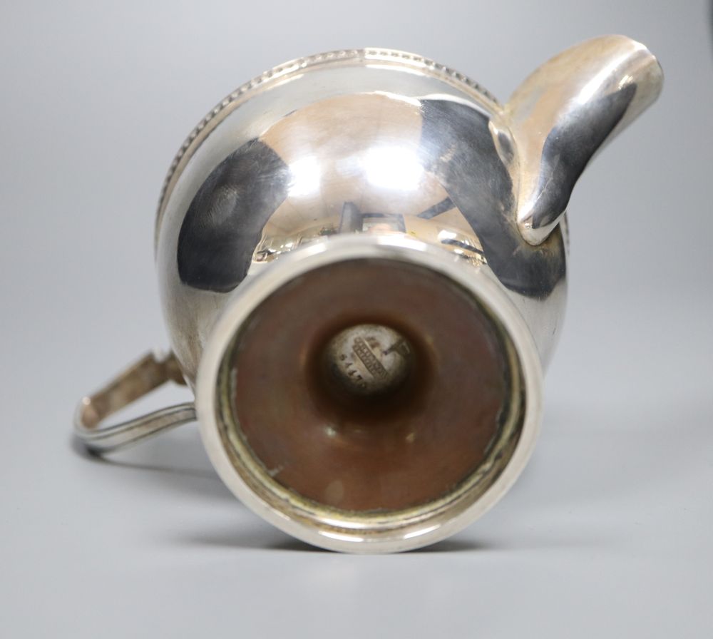 A George V silver pedestal cream jug, Walker & Hall, Sheffield, 1930, 85mm,